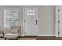 Bright entryway featuring a white front door, hardwood floors, and a neutral color scheme at 1331 Walker Ave, Atlanta, GA 30344