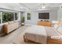 Spacious bedroom with natural light, modern décor, and wood-look flooring at 6095 Blackberry Ln, Buford, GA 30518
