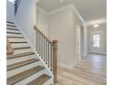 Elegant staircase with dark wood and wrought-iron railing leading to the second floor at 4443 Eastbrook Pl, Snellville, GA 30039