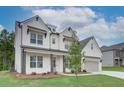 Beautiful two-story house with white painted brick, and black trim at 409 West March Cir, Loganville, GA 30052