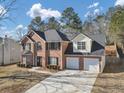 Two-story brick home, two-car garage, mature trees and landscaping at 5854 Cobalt Dr, Powder Springs, GA 30127