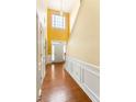 Bright foyer with hardwood floors, high ceilings, and a large window above the front door at 532 Goldfinch Way, Stockbridge, GA 30281