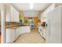 Spacious kitchen with white cabinets, tile countertops, and a cozy breakfast nook at 532 Goldfinch Way, Stockbridge, GA 30281
