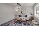 Bright living room features a comfy sofa, stylish rug, and modern lighting at 3611 Hillsborough Ln, Decatur, GA 30032