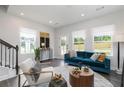 Bright living room showcasing hardwood floors, modern furniture, and large windows at 373 Skylar Se Way, Atlanta, GA 30315