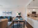 Well-lit open-concept kitchen featuring a dining area and modern appliances at 1100 Howell Mill Rd # 404, Atlanta, GA 30318