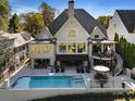 The backyard features a beautiful pool, patio area, and a unique spiral staircase at 6308 Woodlake Dr, Buford, GA 30518