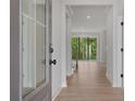 Welcoming entryway with hardwood floors, a clear view of the staircase, and ample natural light from the sidelight window at 7530 Homer Dr, Cumming, GA 30028