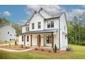 Charming two-story home with white siding, a metal roof, and a covered front porch at 1709 Eastside Parc St, Atlanta, GA 30316