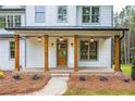 Charming front porch with wood columns and elegant lighting fixtures at 1709 Eastside Parc St, Atlanta, GA 30316