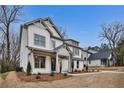 Charming two-story white home with gray trim, landscaped front yard, and covered front porch at 1697 Eastside Parc St, Atlanta, GA 30316