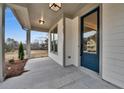 Inviting covered front porch with a blue front door and view of the front yard at 1697 Eastside Parc St, Atlanta, GA 30316