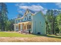 Beautiful craftsman home boasts a covered front porch and lush greenery at 1702 Eastside Parc St, Atlanta, GA 30316