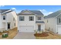 Two-story home with white siding, gray shutters, and a two-car garage at 11963 Conrad Cir, Hampton, GA 30228