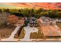 A high angle view of a neighborhood lot featuring a two-story home, a sprawling driveway, and lush landscaping at 159 Shadburn Ferry Rd, Buford, GA 30518