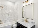 Stylish bathroom with marble tiled shower, modern vanity, and elegant gold fixtures at 2611 Charlesgate Ave, Decatur, GA 30030