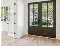 Elegant entryway featuring hardwood floors and glass paneled double doors letting in natural light at 2611 Charlesgate Ave, Decatur, GA 30030