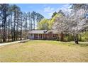 Well-maintained single-story home, mature trees, and a spacious front yard at 2420 Green Rd, Loganville, GA 30052