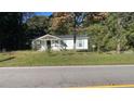 Charming single-story home featuring a minimalist landscape and surrounded by mature trees at 698 Rocky Plains Rd, Covington, GA 30016