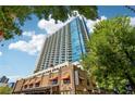 Striking exterior view of a modern high-rise building with balconies and commercial space at 860 Peachtree Ne St # 1903, Atlanta, GA 30308