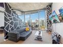 Stylish living room with modern decor, city views, and a comfortable seating area at 860 Peachtree Ne St # 1903, Atlanta, GA 30308