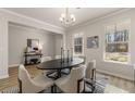 Bright dining room with hardwood floors, chandelier, and modern dining set at 495 Hancock Se Dr, Atlanta, GA 30354