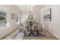 Bright dining room with hardwood floors, chandelier, and modern dining set at 495 Hancock Se Dr, Atlanta, GA 30354