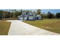 Desirable curb appeal with long driveway leading up to a two-story home and attached three car garage at 255 Old Town Rd, Dacula, GA 30019
