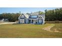 Beautiful two-story home with a large front lawn on a sunny day at 255 Old Town Rd, Dacula, GA 30019