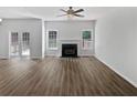 Open-concept living room featuring a fireplace, modern floors, and ample natural light from several windows at 200 Eagle Glen Ct, Woodstock, GA 30189