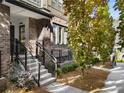 Beautiful brick townhome with manicured landscaping, concrete stairs and elegant black iron railings at 383 Pratt Se Dr # 503, Atlanta, GA 30315