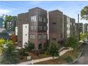 Modern townhome complex featuring contemporary architecture with brick and metal facade details and mature landscaping at 383 Pratt Se Dr # 503, Atlanta, GA 30315