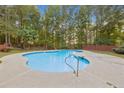 Refreshing kidney-shaped pool with brick wall backdrop at 512 Clearwater Dr, Mcdonough, GA 30252