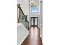 Elegant entryway with hardwood floors, a staircase, and double doors at 5400 Deer Run Dr, Conyers, GA 30094