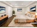 Staged bedroom features contemporary furniture, decor, and hardwood floors at 5394 Muirwood Pl, Powder Springs, GA 30127
