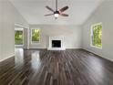 Bright living room boasts hardwood floors and a white painted fireplace at 5394 Muirwood Pl, Powder Springs, GA 30127