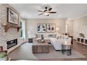 Inviting living room with a stone fireplace, modern furnishings, neutral decor, and plenty of natural light at 151 Sunshower Rdg, Canton, GA 30114