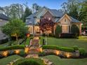 Charming two-story home with professionally landscaped front yard and elegant stone walkway at 1319 Glen Cedars Dr, Smyrna, GA 30126