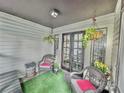 Relaxing screened porch with wicker chairs and hanging plants at 4359 Idlewood Ln, Tucker, GA 30084