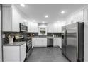 Modern kitchen with stainless steel appliances and dark gray backsplash at 2735 Stonecreek Se Rd, Smyrna, GA 30080