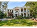 Stately multi-level condominium featuring lush green landscaping, stucco walls and tile roof at 856 Briarcliff Ne Rd # 5, Atlanta, GA 30306