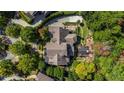 Drone view of the luxury home, showcasing the roofline, and a landscaped backyard at 980 Fenimore Cir, Sandy Springs, GA 30350