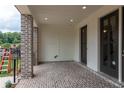 Covered patio with brick flooring, elegant trim, and access to outdoor spaces at 332 Olmstead Way # 38, Alpharetta, GA 30022