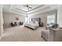 Large main bedroom with sitting area, trey ceiling, and neutral tones and large windows at 2423 Rosapenna Nw Ln, Kennesaw, GA 30152