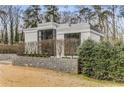 Modern home with large windows and mature landscaping, creates a private and inviting atmosphere at 3184 Wood Valley Nw Rd, Atlanta, GA 30327