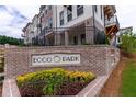 ECCO Park signage in front of new townhome community with colorful landscaped flower bed at 344 Olmstead Way # 32, Alpharetta, GA 30022