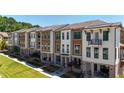 Charming new construction townhomes featuring a mix of brick, siding, and private balconies at 344 Olmstead Way # 32, Alpharetta, GA 30022