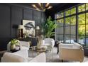 Cozy living room features modern decor, black accent walls, and large windows overlooking the serene outdoors at 3290 Dunlop Ne Ct, Brookhaven, GA 30319