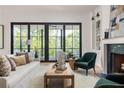 Inviting living room with fireplace, built-in bookshelves, and sliding glass doors to outdoor living space at 3290 Dunlop Ne Ct, Brookhaven, GA 30319