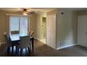 Inviting dining area with a ceiling fan, wood floors, and a view of the outdoors at 300 Flagstone Way, Austell, GA 30168
